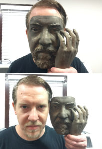 Mask of man shown in bronze, before patina was applied. 